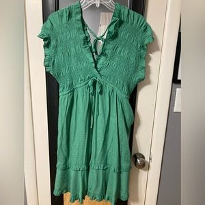 Glam mini dress with pockets, smocked top and ruffle detail skirt. Size small